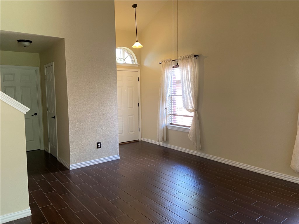 1257 Pine Portage Loop Leander, TX 78641 - Photo 5 of 32 Foyer entrance featuring a high ceiling and dark wood tiled floors