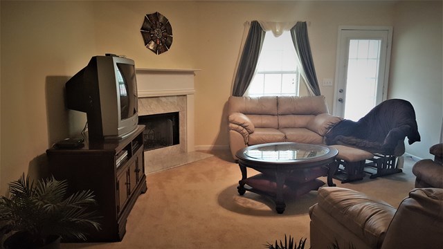 3335 Trotters Ridge Trail Gray, GA 31032 - Photo 3 of 25 a living room with furniture and a fireplace