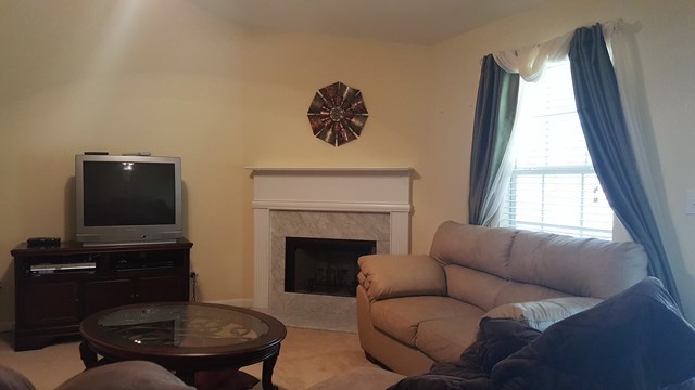 3335 Trotters Ridge Trail Gray, GA 31032 - Photo 10 of 25 a living room with furniture and a fireplace