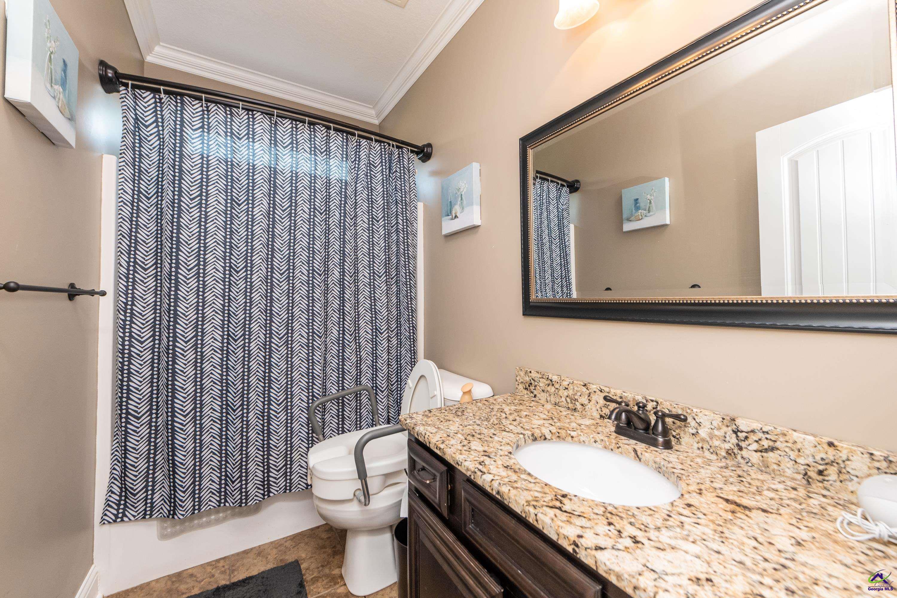 405 Old Bridge Road Warner Robins, GA 31088 - Photo 32 of 58 a bathroom with a granite countertop sink toilet and mirror