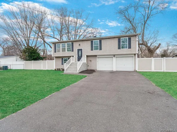 a front view of house with yard and green space