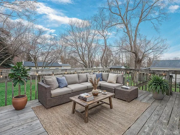 a backyard of a house with table and chairs