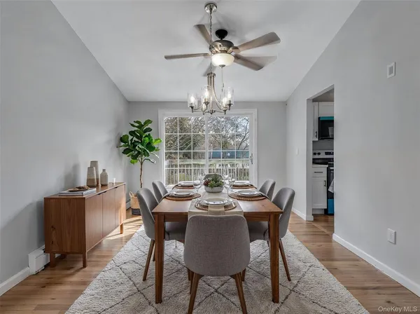 a view of a dining room with furniture window and wooden floor