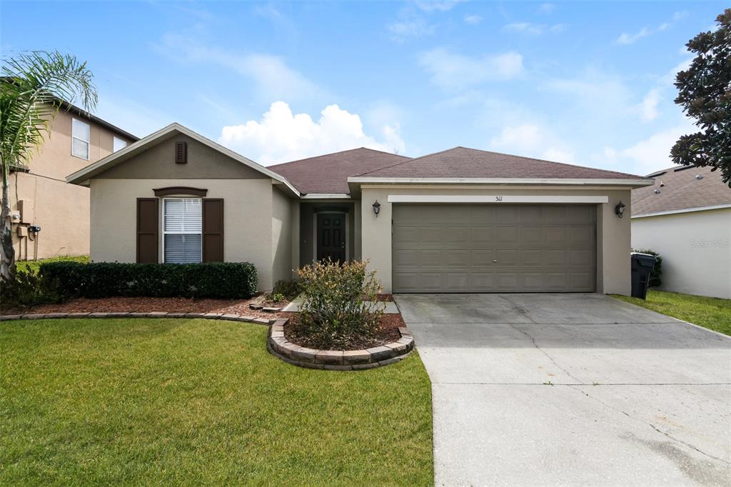 511 Elderberry Drive Davenport, FL 33897 - Photo 1 of 1 a front view of house with yard and garage