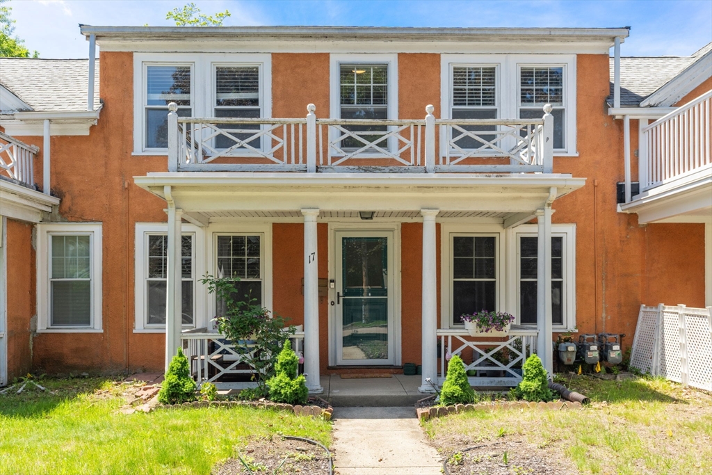 front view of a brick house with a large windows