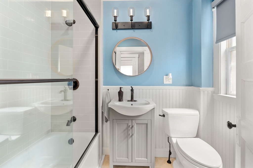 17 Maple Street, Unit 17 Needham, MA 02492 - Photo 19 of 24 a bathroom with a sink a toilet and shower