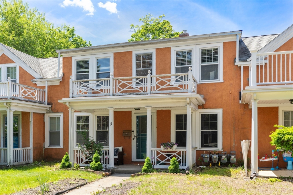 17 Maple Street, Unit 17 Needham, MA 02492 - Photo 2 of 24 a view of a house with a yard lawn chairs and a yard