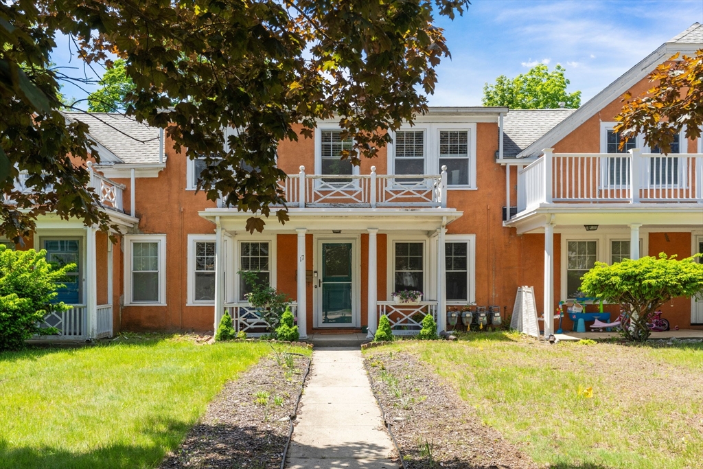 17 Maple Street, Unit 17 Needham, MA 02492 - Photo 3 of 24 front view of a house with a yard
