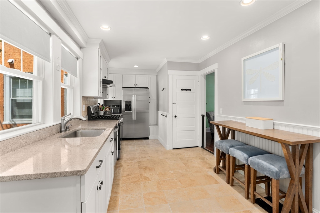 17 Maple Street, Unit 17 Needham, MA 02492 - Photo 10 of 24 a kitchen with stainless steel appliances granite countertop a sink stove and refrigerator