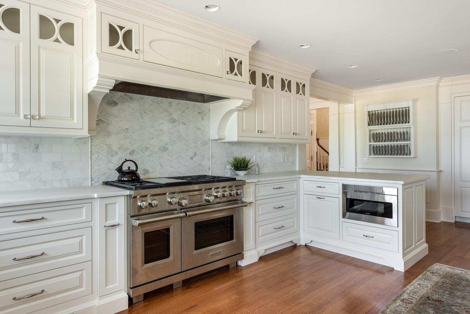 56 Rendezvous Lane Barnstable, MA 02630 - Photo 12 of 35 a kitchen with stainless steel appliances white cabinets and stove