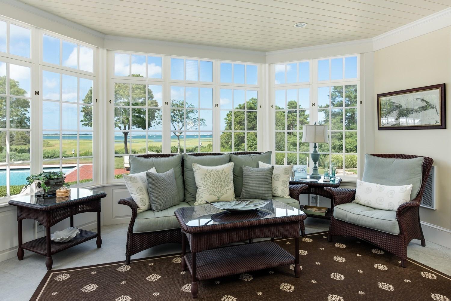 56 Rendezvous Lane Barnstable, MA 02630 - Photo 15 of 35 a living room with furniture and a floor to ceiling window