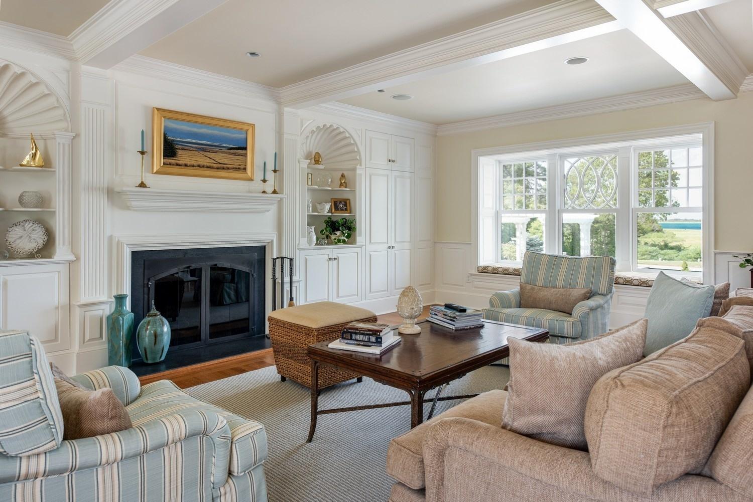 56 Rendezvous Lane Barnstable, MA 02630 - Photo 16 of 35 a living room with furniture a large window and a fireplace