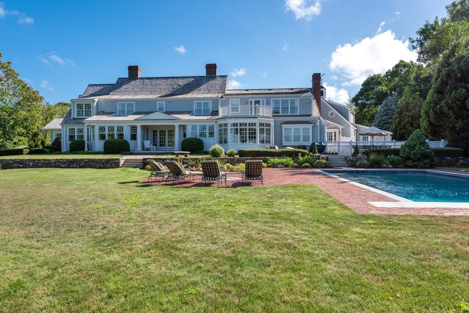 56 Rendezvous Lane Barnstable, MA 02630 - Photo 3 of 35 a front view of a building with garden and trees