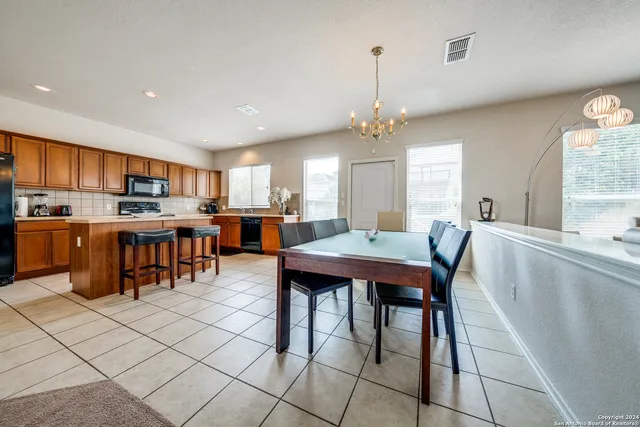 a large kitchen with a table and chairs