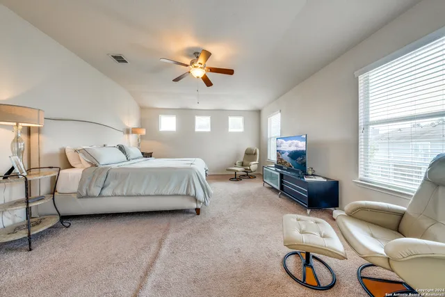 a bedroom with bed and a couch