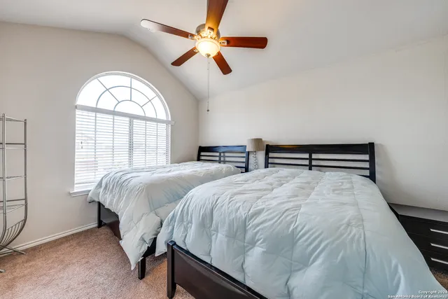 a bedroom with a bed and a large window