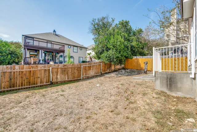 a view of a house with wooden fence