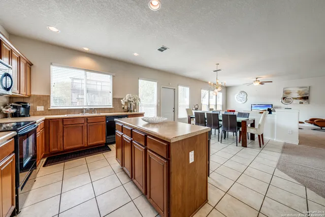 a kitchen with stainless steel appliances granite countertop a sink and a stove