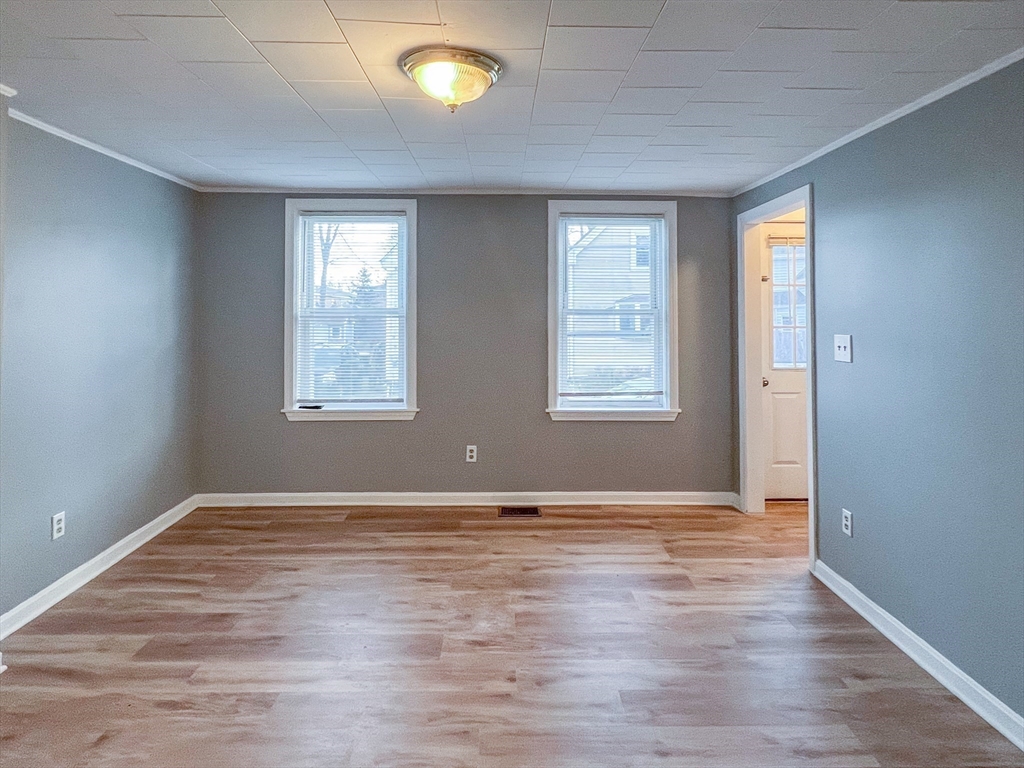 19-25 Common Street Weymouth, MA 02188 - Photo 12 of 41 an empty room with wooden floor and windows