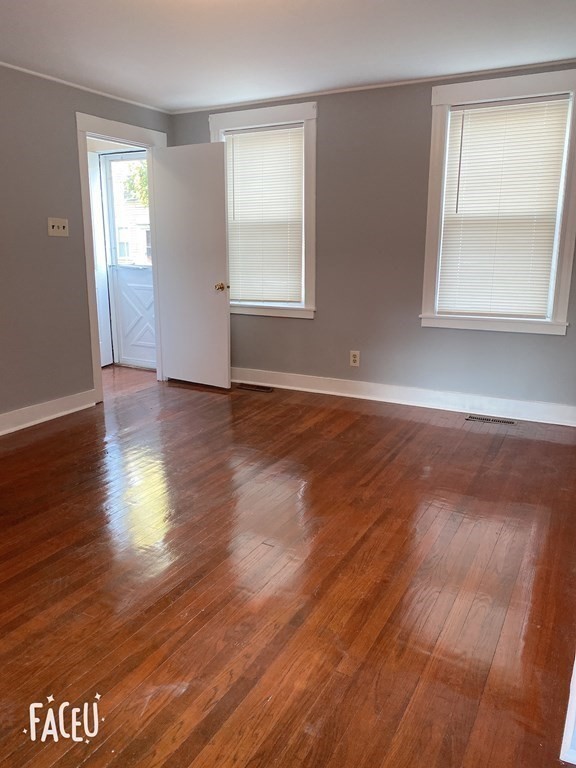 19-25 Common Street Weymouth, MA 02188 - Photo 15 of 41 an empty room with wooden floor and windows