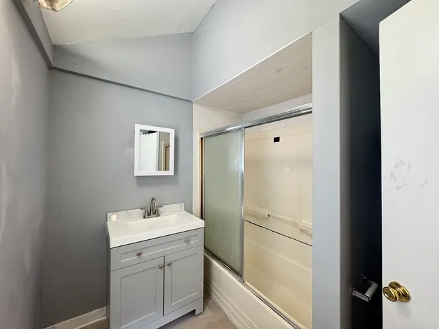 a bathroom with a sink mirror and toilet