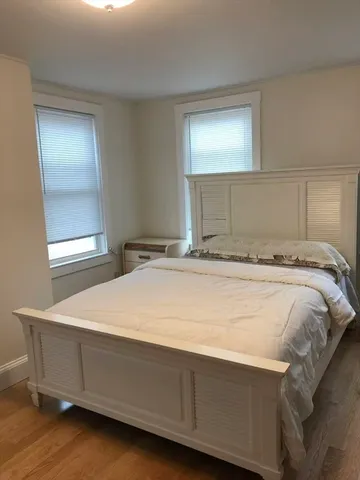 a bedroom with a bed and window