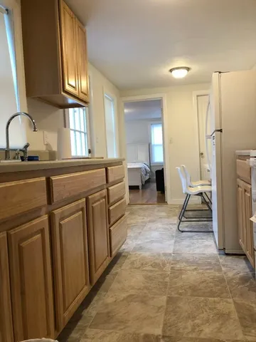 a living room with furniture a mirror and a sink