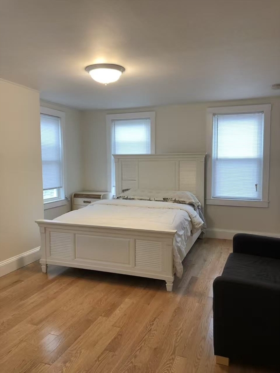 19-25 Common Street Weymouth, MA 02188 - Photo 41 of 41 a spacious bedroom with a bed and a couch