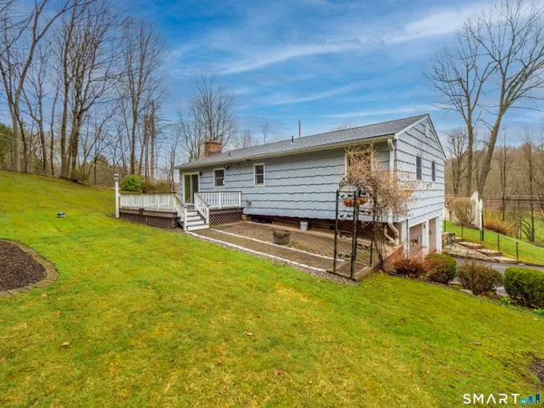 a view of a house with backyard porch and sitting area