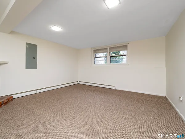 an empty room with furniture and a fireplace