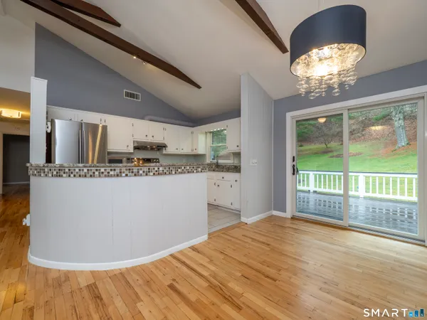 a view of a kitchen with a dishwasher cabinets and a floor to ceiling window