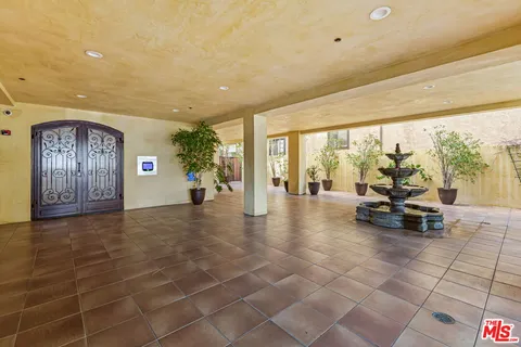 a view of a livingroom with furniture and floor to ceiling window