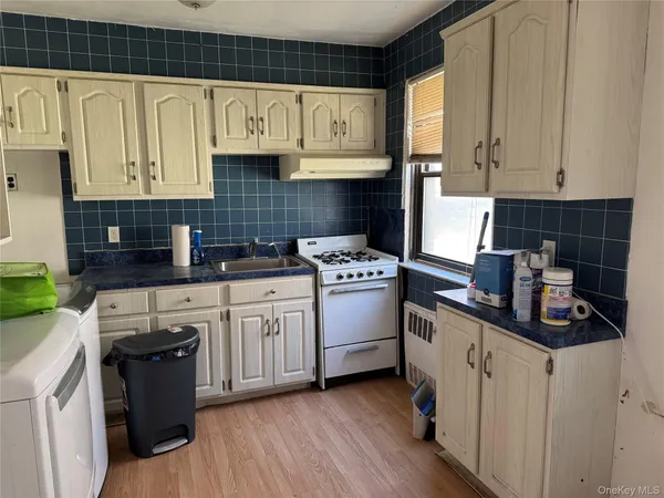 a kitchen with stainless steel appliances granite countertop a sink a stove and cabinets
