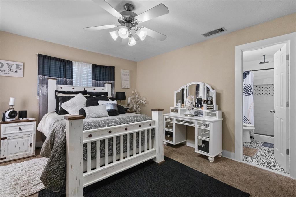137 North Jessup Street Alvarado, TX 76009 - Photo 11 of 23 a bedroom with a bed a chandelier and dresser