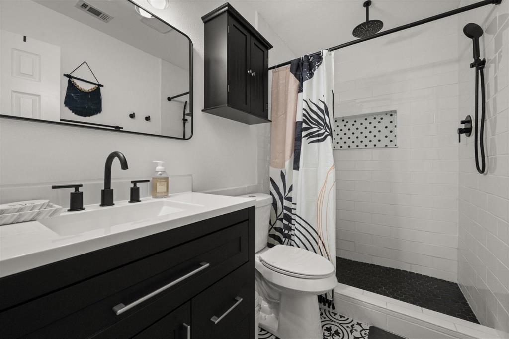 137 North Jessup Street Alvarado, TX 76009 - Photo 12 of 23 a bathroom with a sink a toilet and shower