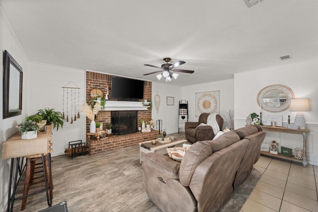 137 North Jessup Street Alvarado, TX 76009 - Photo 4 of 23 a living room with furniture a fireplace and a flat screen tv