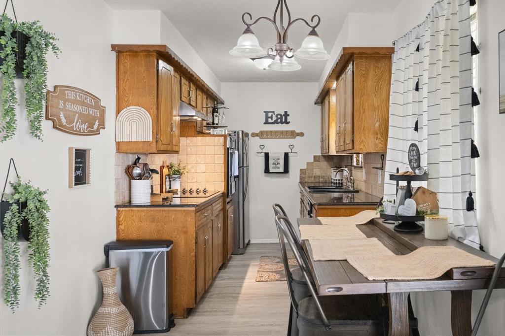 137 North Jessup Street Alvarado, TX 76009 - Photo 6 of 23 a view of a dining room with furniture a chandelier and wooden floor