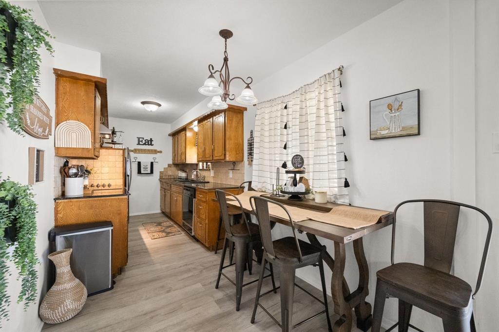 137 North Jessup Street Alvarado, TX 76009 - Photo 7 of 23 a view of a dining room with furniture and wooden floor