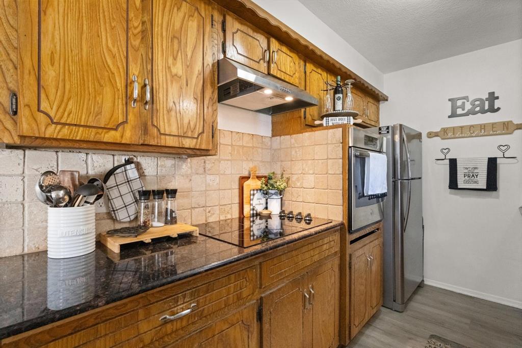 137 North Jessup Street Alvarado, TX 76009 - Photo 8 of 23 a kitchen with stainless steel appliances granite countertop a refrigerator and a sink