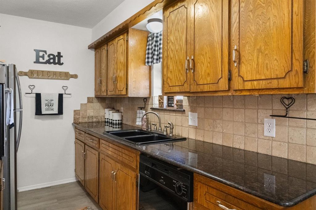 137 North Jessup Street Alvarado, TX 76009 - Photo 9 of 23 a kitchen with stainless steel appliances granite countertop a sink a stove and a microwave