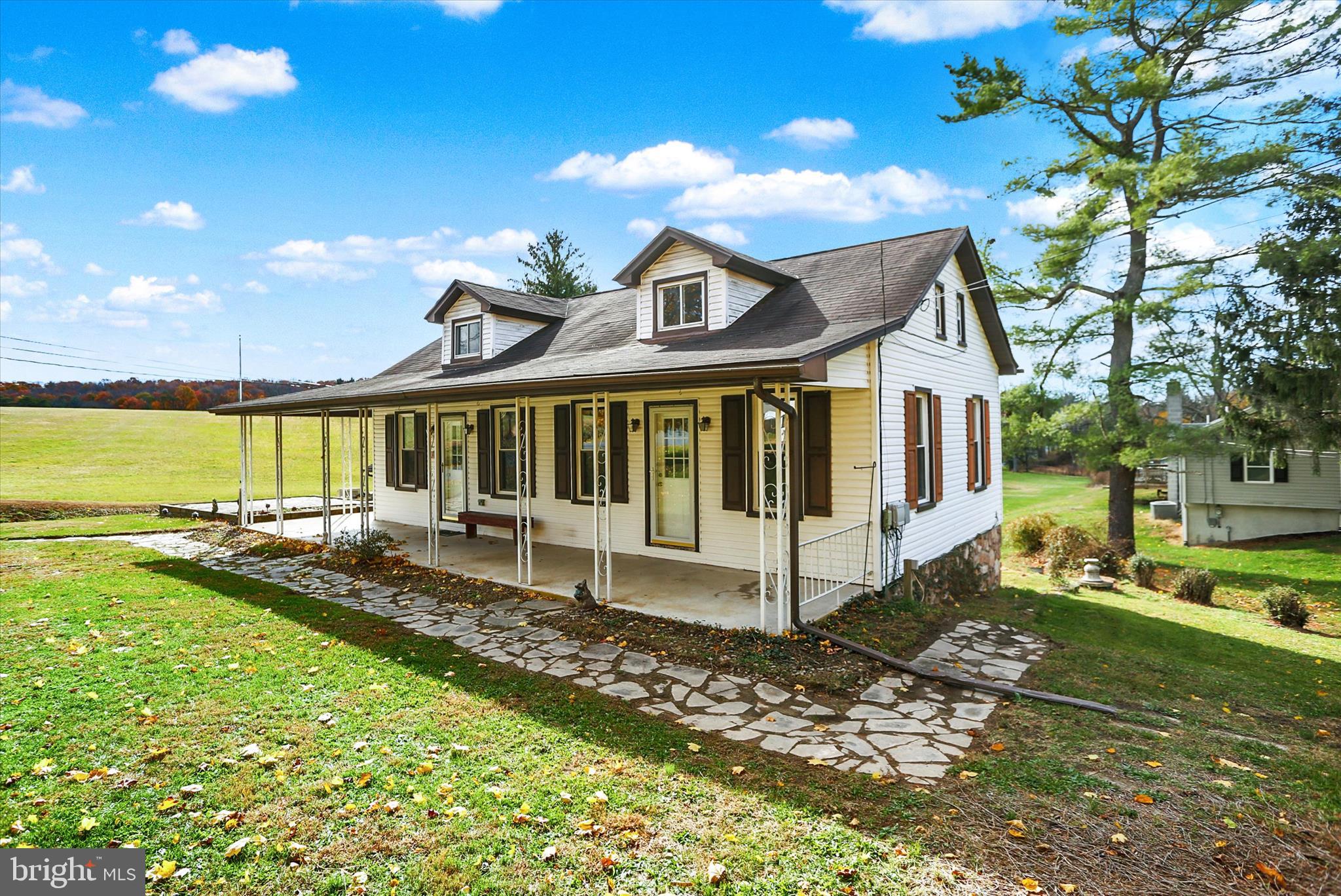 a view of a house with a yard balcony and sitting area