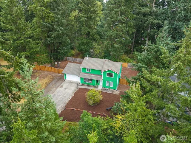 an aerial view of a house with a yard basket ball court and outdoor seating