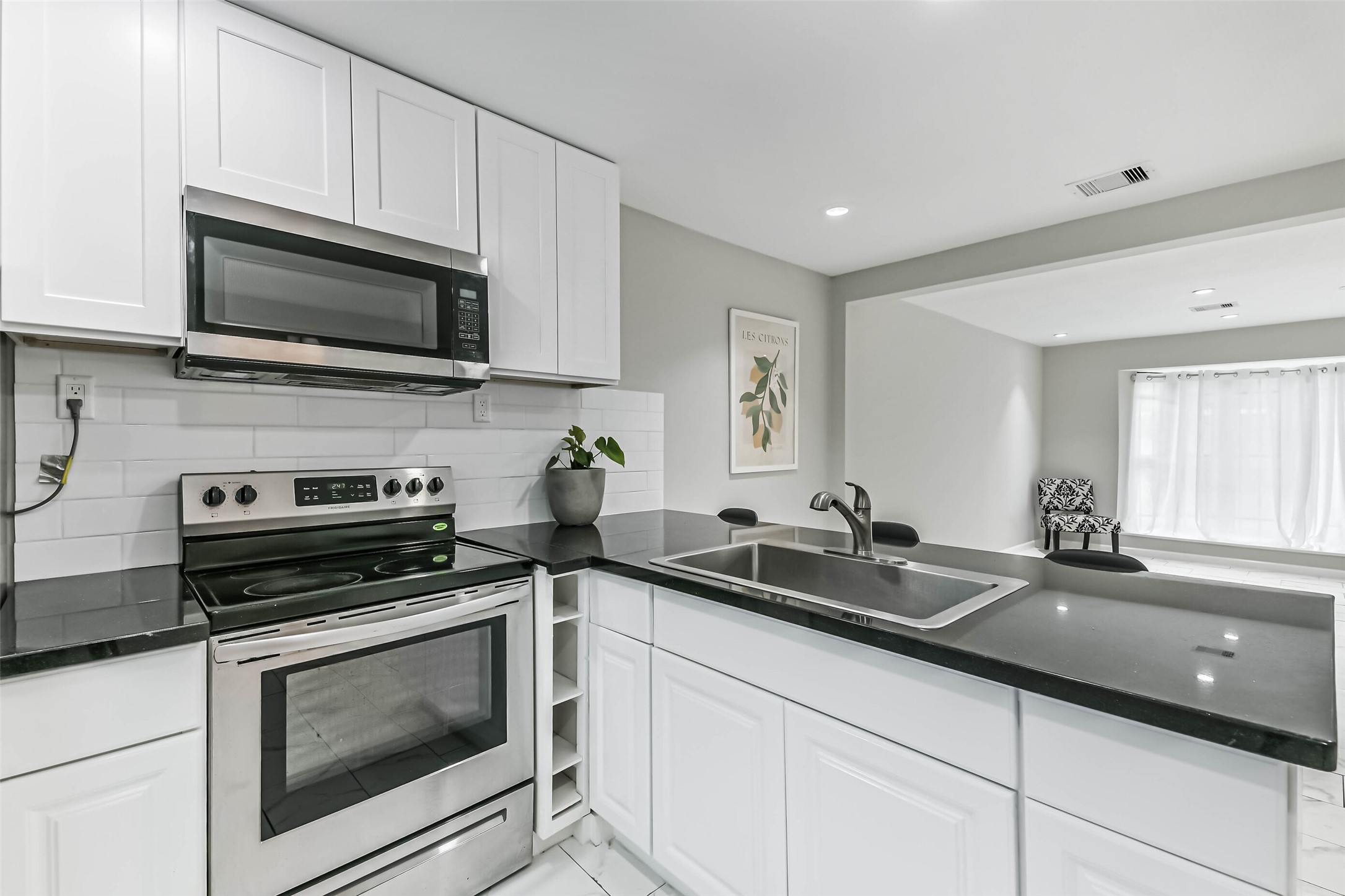 6853 Chasewood Drive Houston, TX 77489 - Photo 9 of 29 a kitchen with a sink and steel appliances