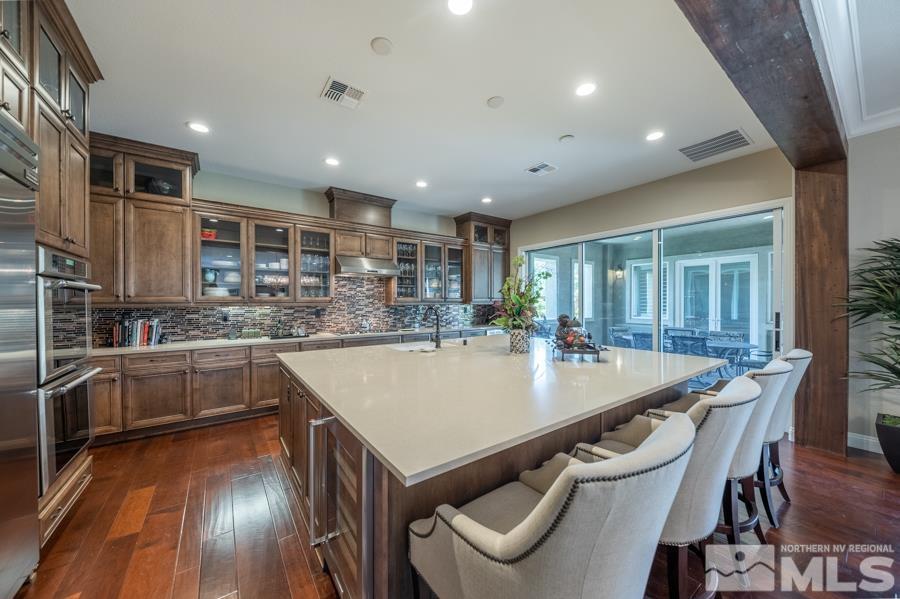 9840 Hafflinger Lane Reno, NV 89521 - Photo 8 of 38 a large kitchen with a table and chairs
