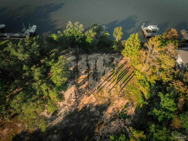an aerial view of a house yard swimming pool and outdoor seating