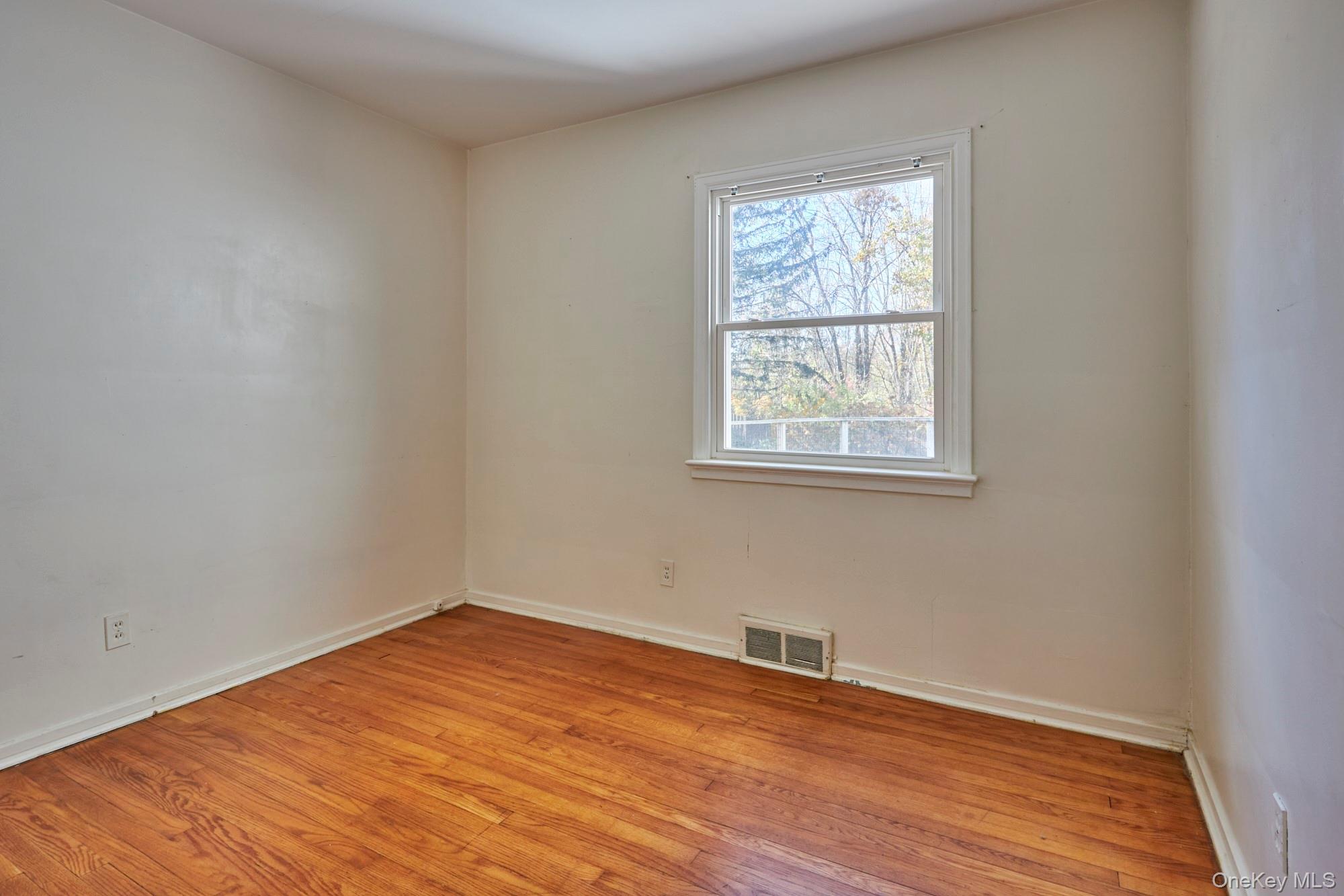 2467 Salt Point Turnpike Clinton Corners, NY 12514 - Photo 13 of 21 an empty room with wooden floor and windows