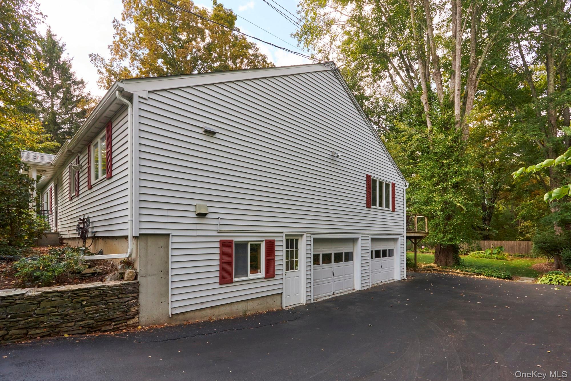 2467 Salt Point Turnpike Clinton Corners, NY 12514 - Photo 21 of 21 a front view of a house with a yard and garage
