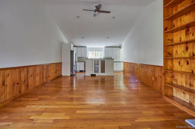 a view of a living room and kitchen with furniture