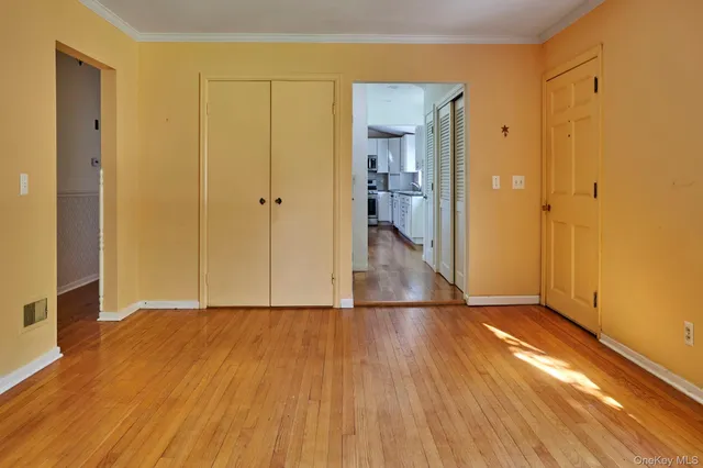 a view of hallway with wooden floor