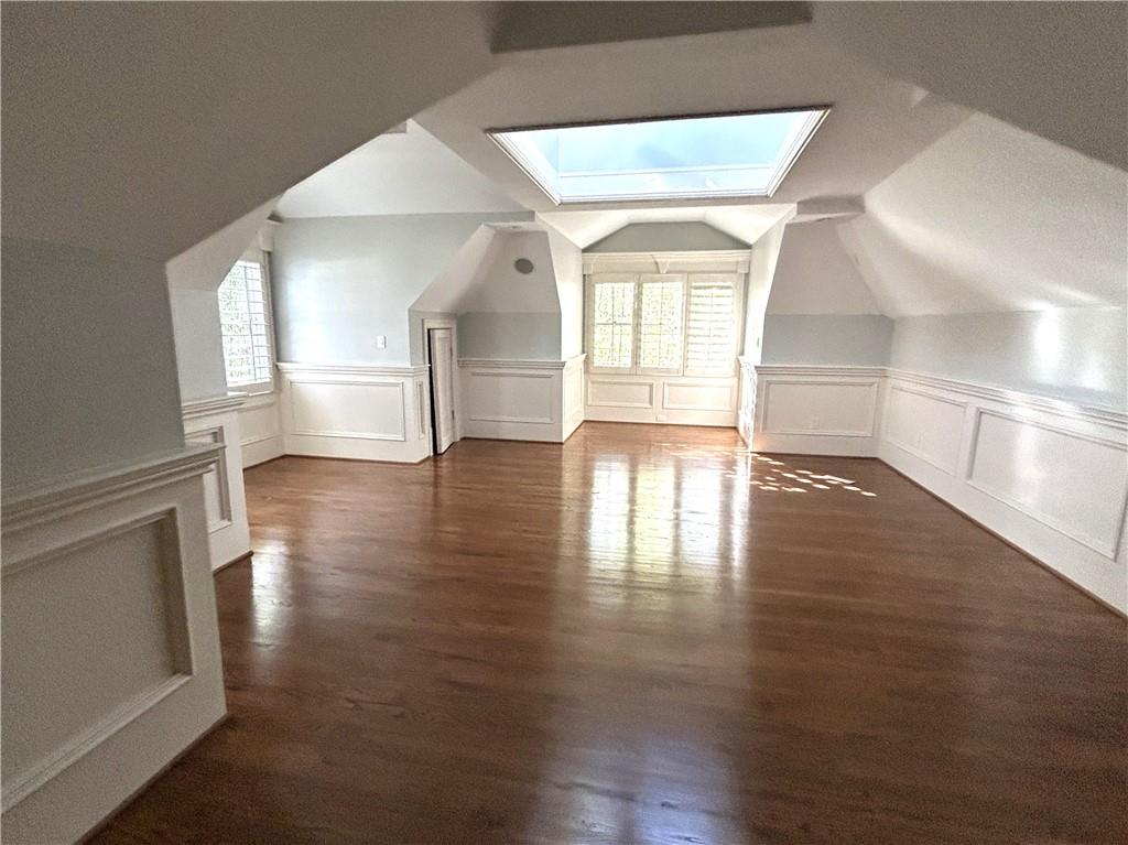 13039 Freemanville Road Alpharetta, GA 30004 - Photo 14 of 28 a view of empty room with wooden floor and fireplace